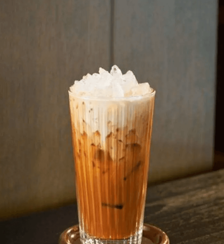 A glass of Thai iced tea over ice