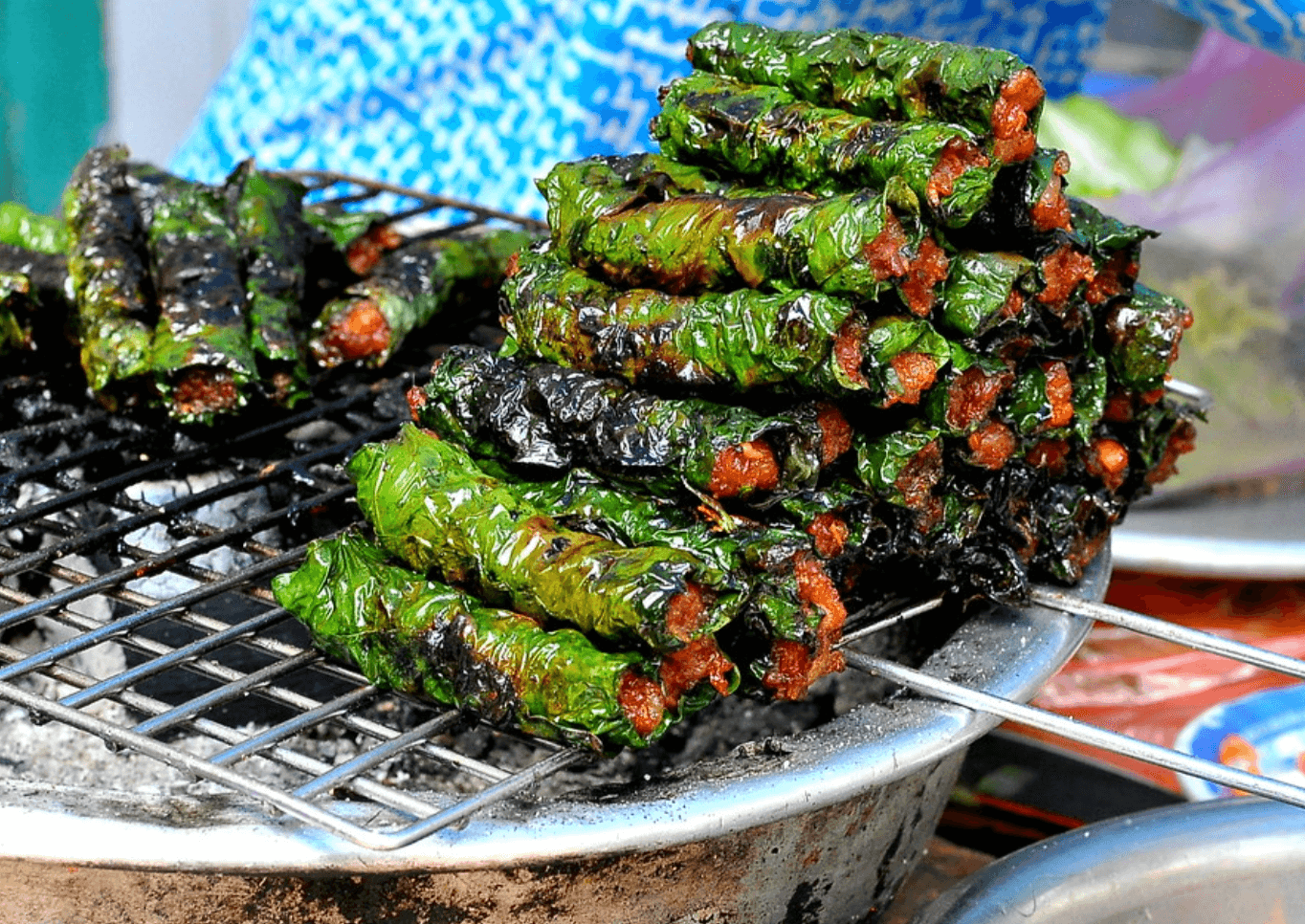 Bo la lot grilling over charcoal at a Ho Chi Minh City street stall