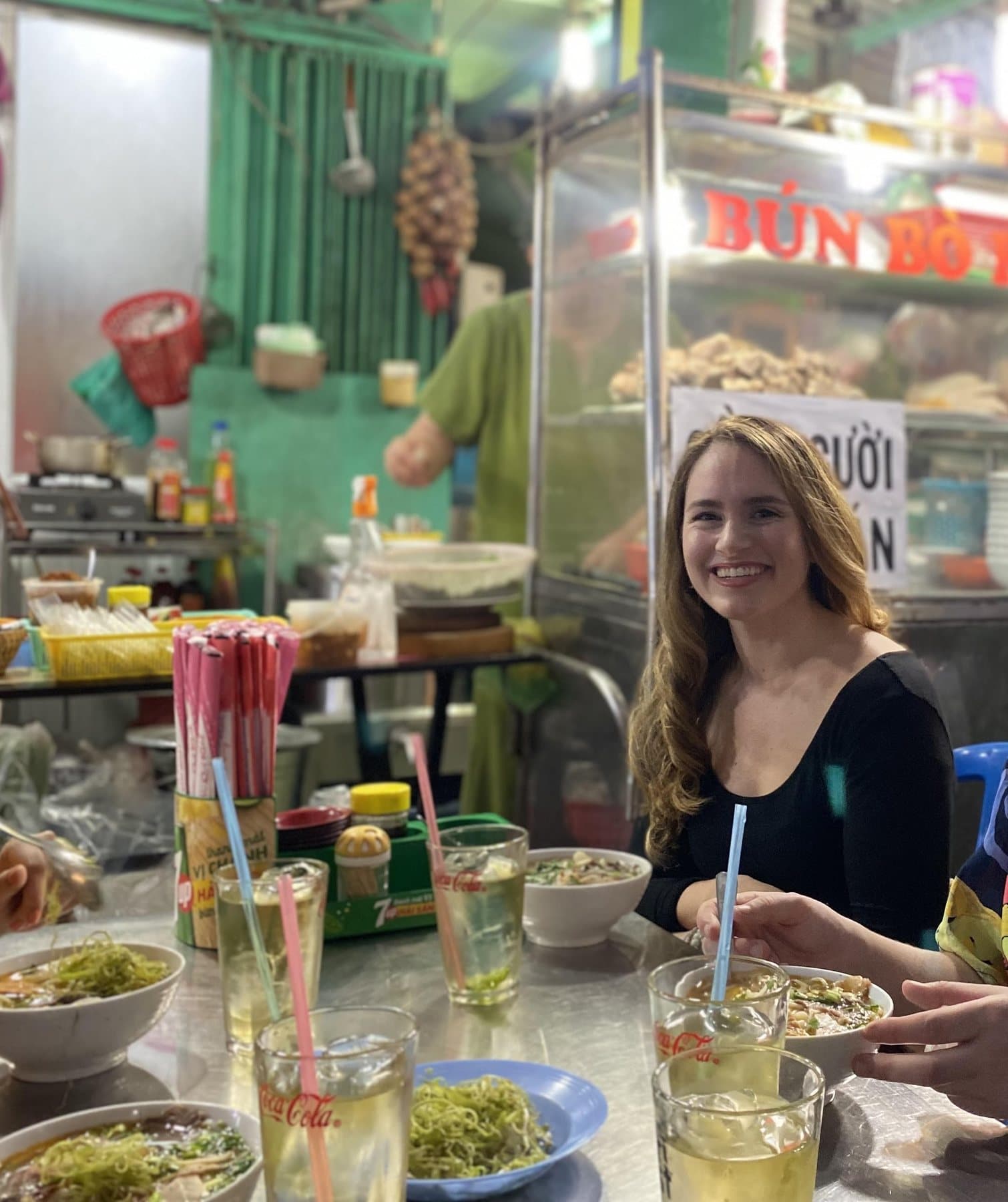 Sarah at a lively street food table