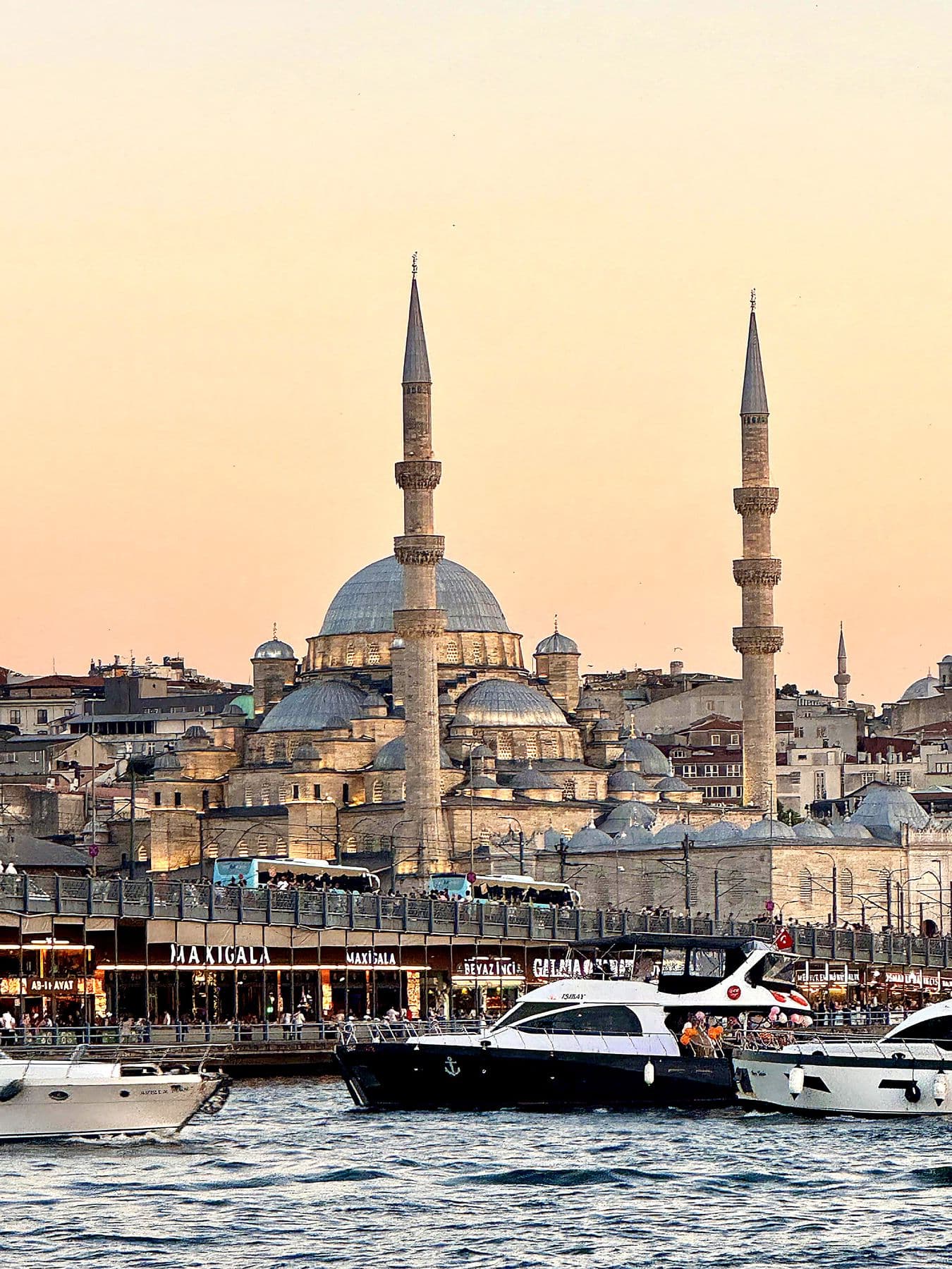 Bosphorus ferries and mosque domes at sunset in Istanbul