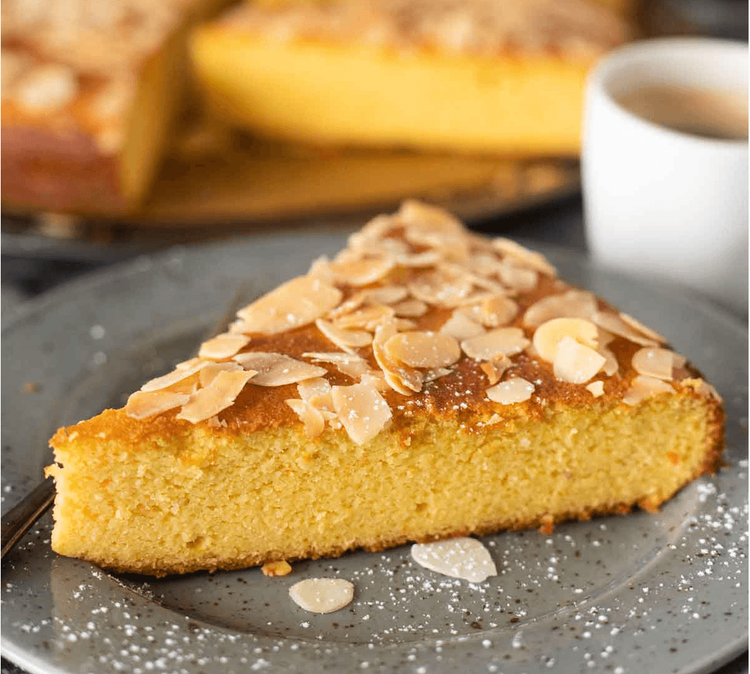 Slice of Dubrovnik almond orange cake topped with sliced almonds