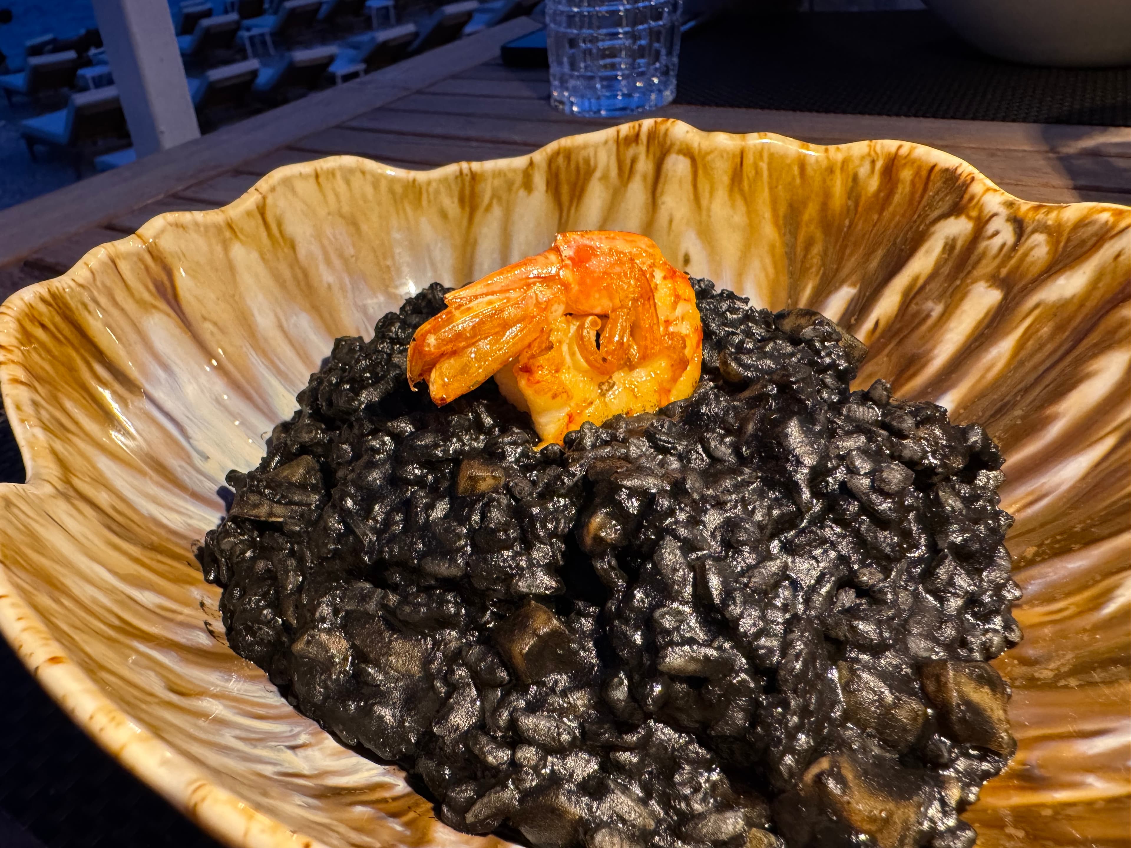 Black ink risotto served with a shrimp on top