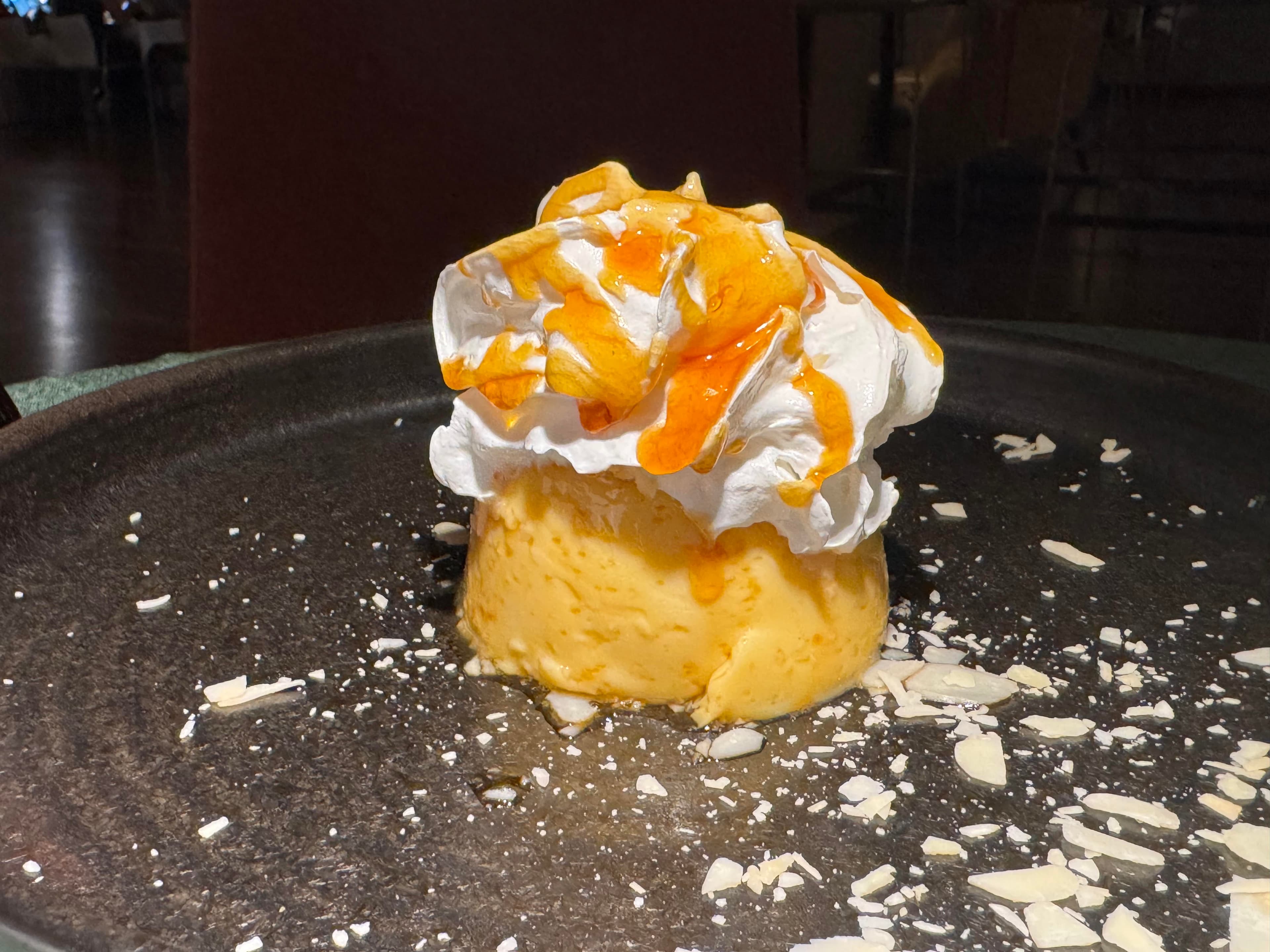 Dubrovnik flan topped with whipped cream and caramel