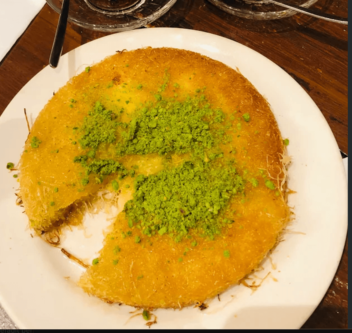 Kunefe dessert topped with pistachios