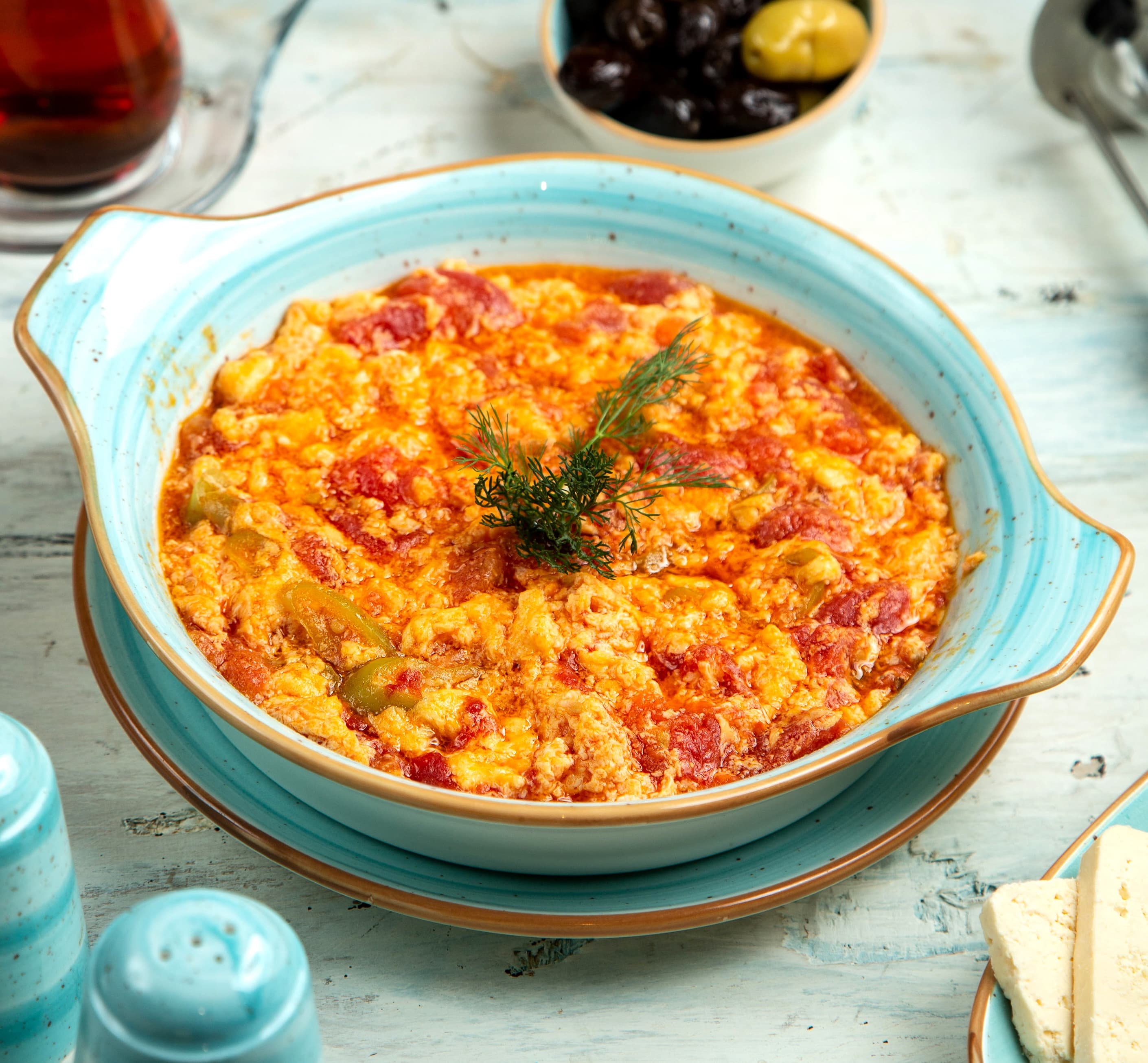 Menemen cooked in a pan with eggs and tomatoes