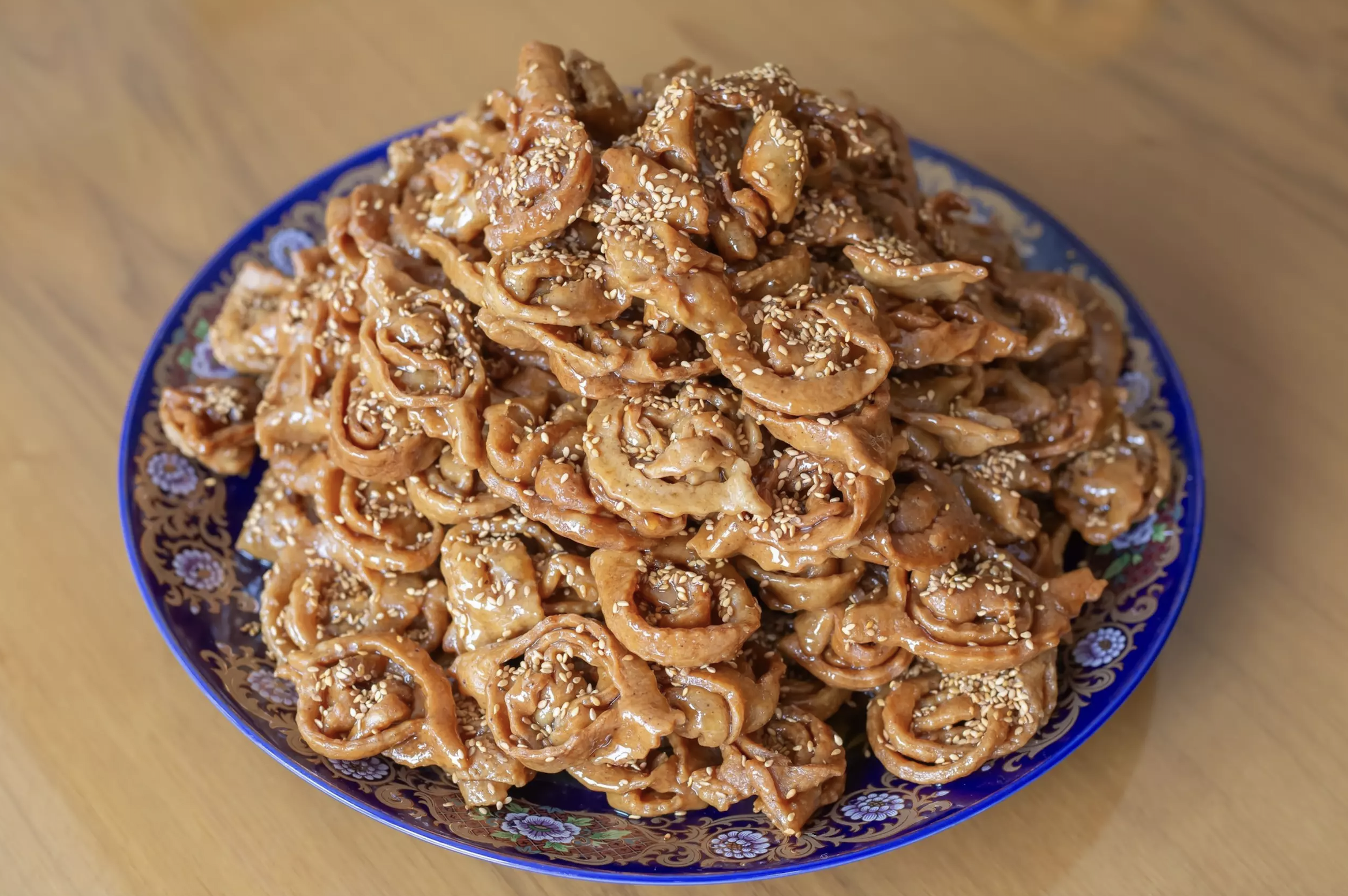 A platter of Marrakesh chebakia coated in honey and topped with sesame seeds