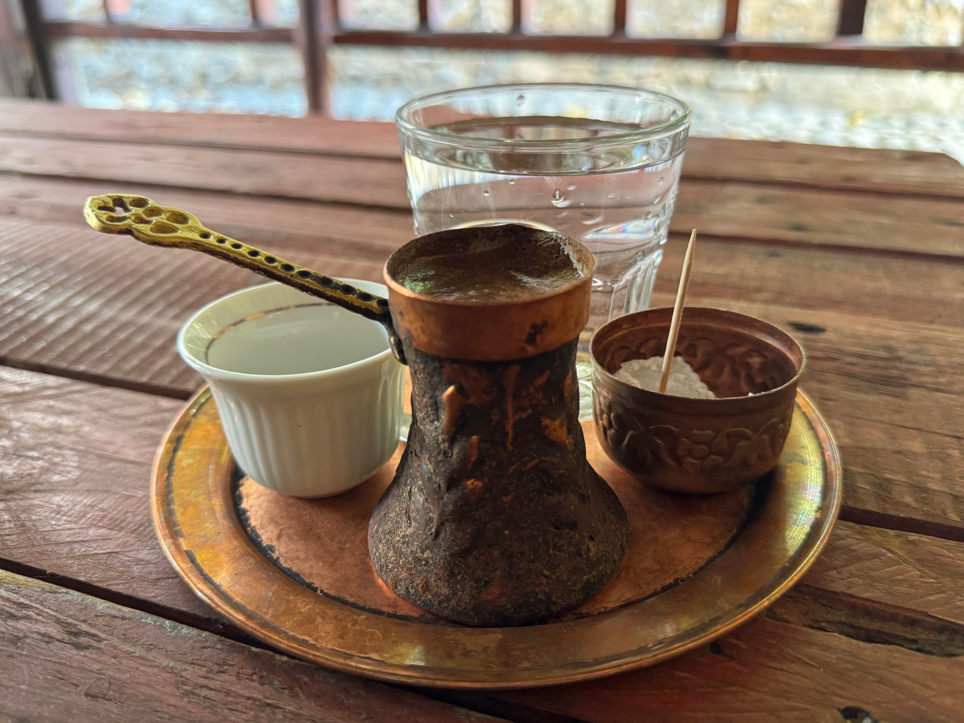 Bosnian coffee service with džezva, cup, sugar, and water in Mostar