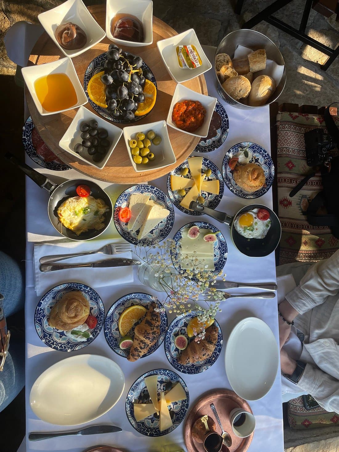 Traditional Herzegovinian breakfast spread with cheeses, olives, eggs, bread, fruit, and preserves in Mostar