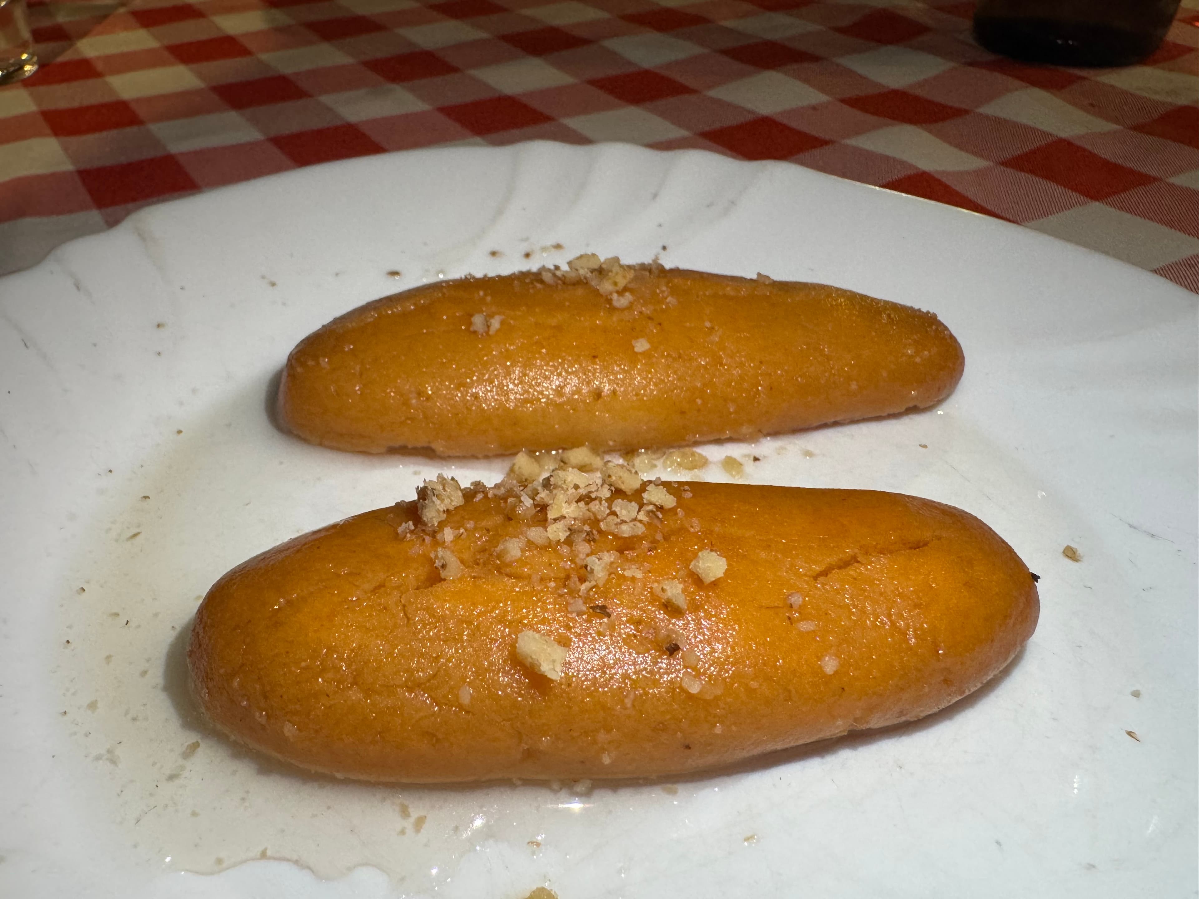 Two hurmasica syrup cakes on a plate in Mostar