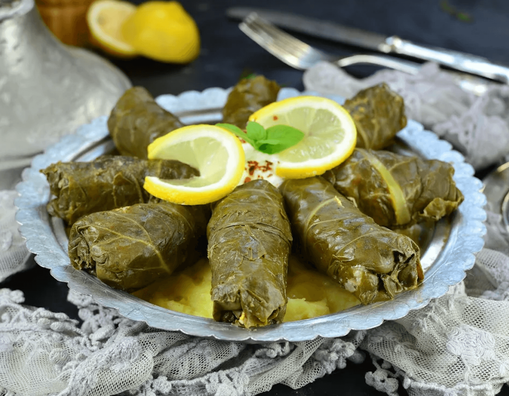 Plate of japrak grape-leaf rolls with lemon in Mostar