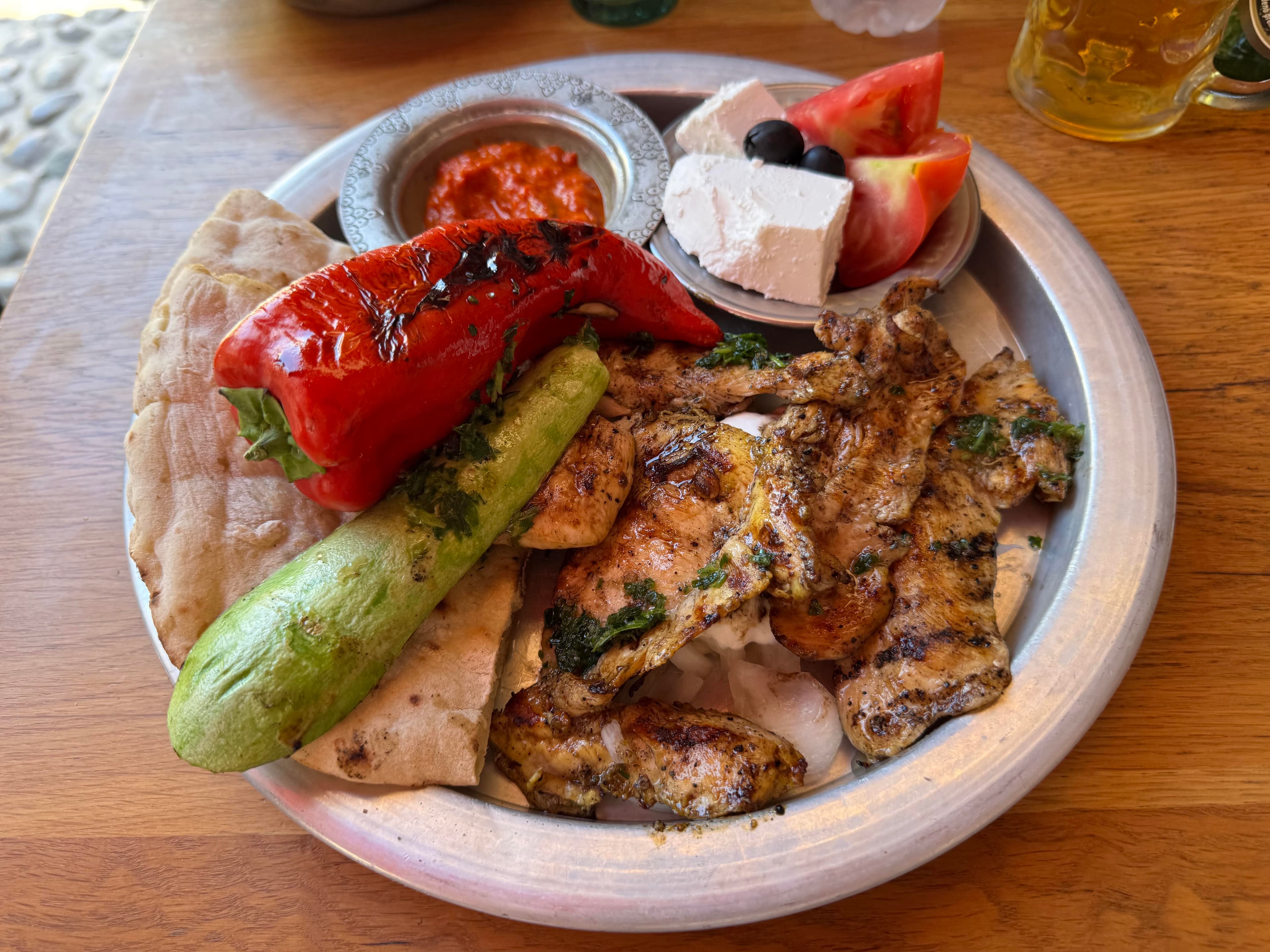 Roštilj platter with grilled meat, vegetables, bread, ajvar, and cheese in Mostar