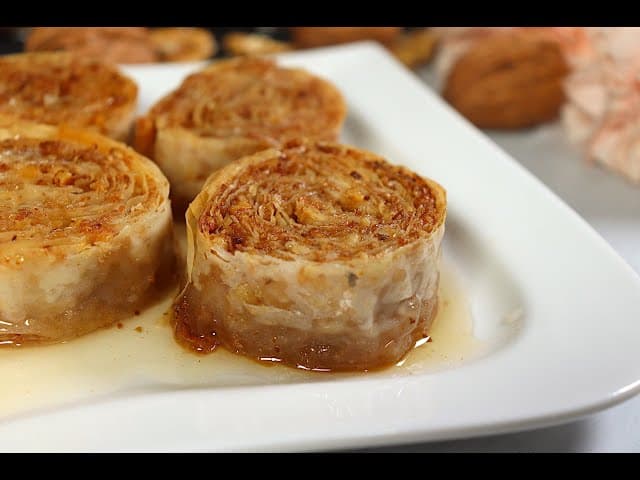 Ružica pastries served on a white plate with syrup