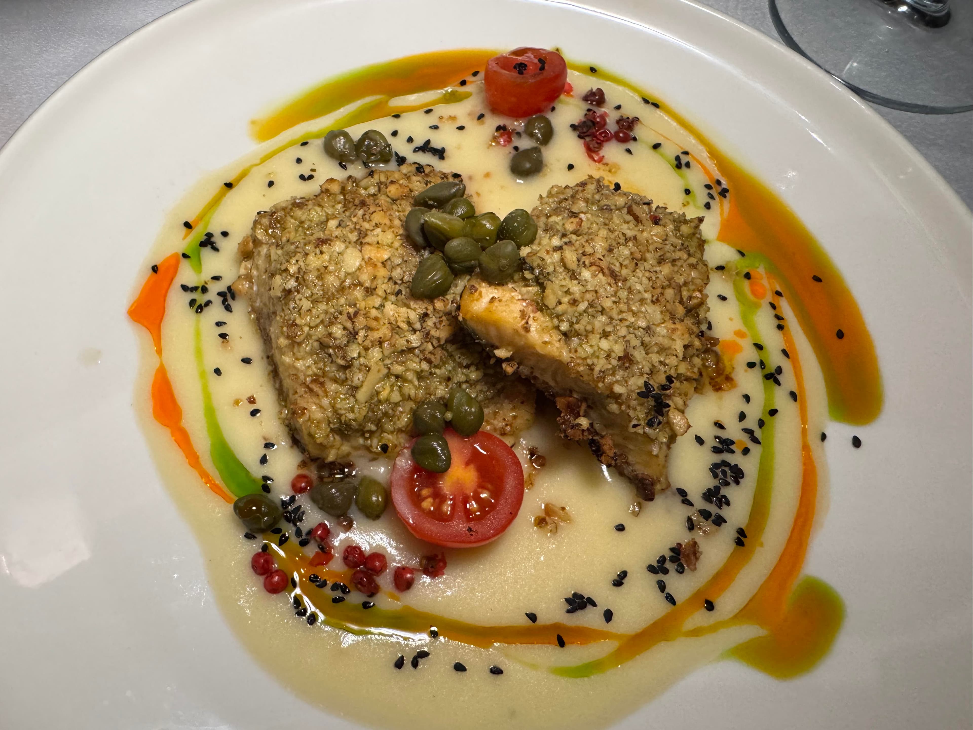 Neretva trout plated over a creamy puree with capers and cherry tomatoes