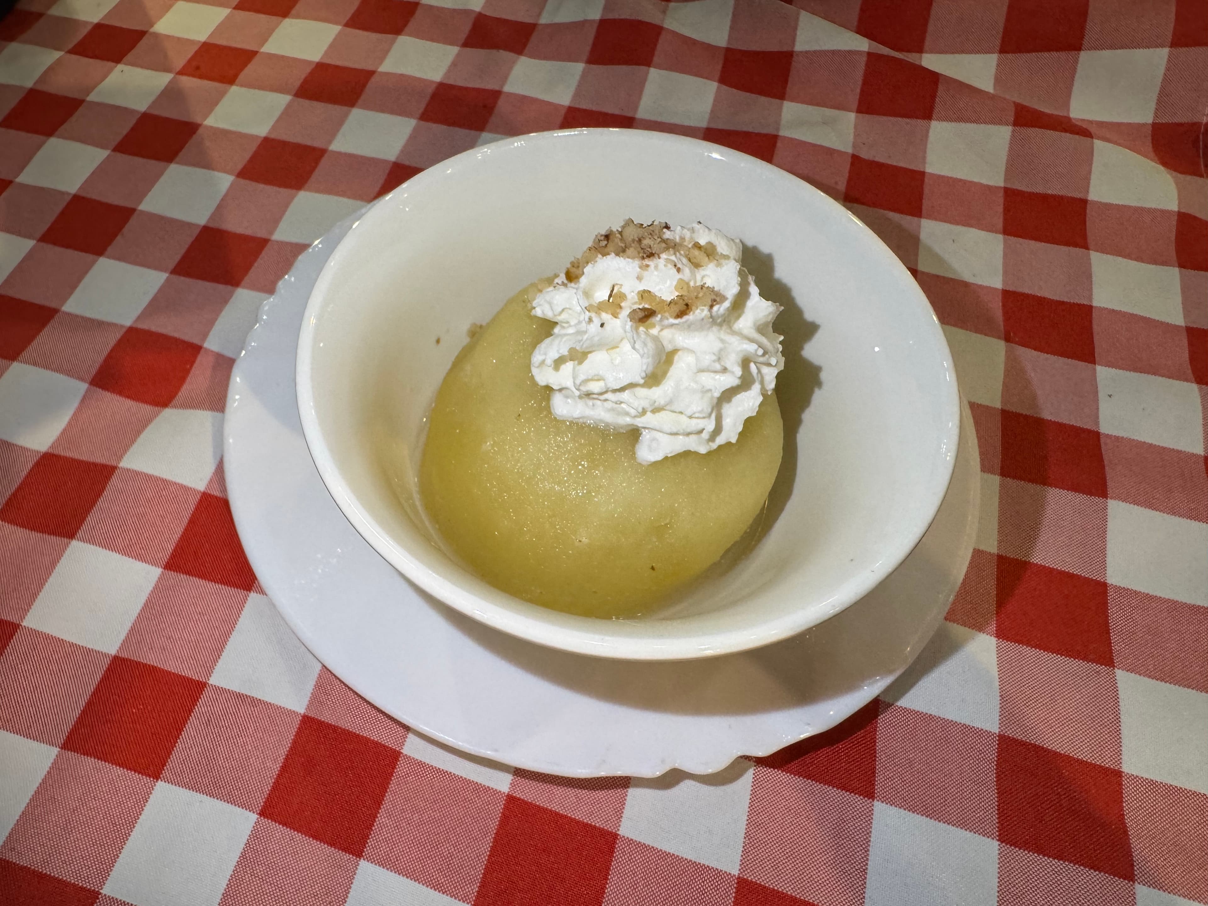 Tufahija served with whipped cream and chopped walnuts in Mostar