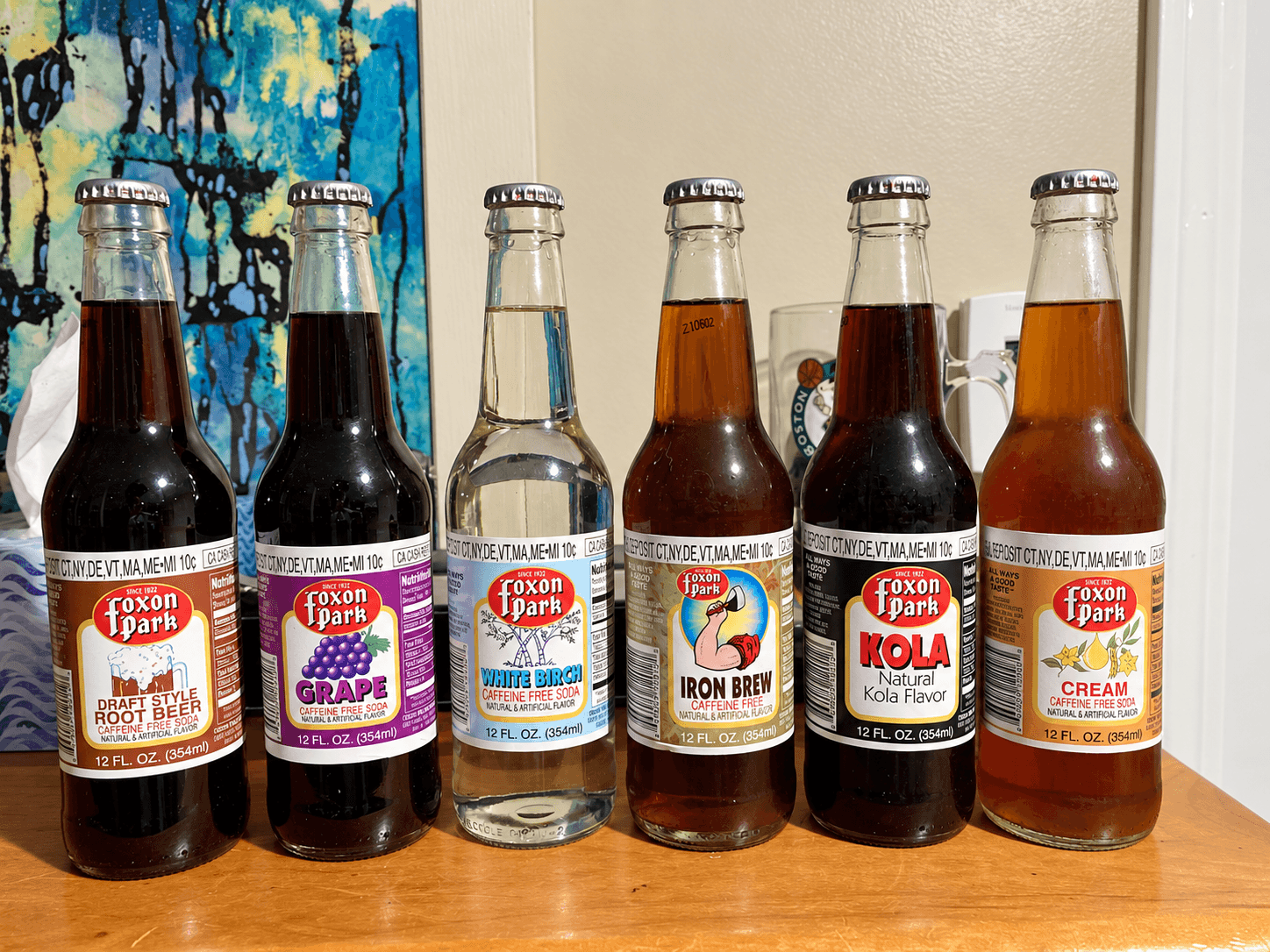 Lineup of six Foxon Park Soda glass bottles including White Birch, Iron Brew, Kola, and Cream