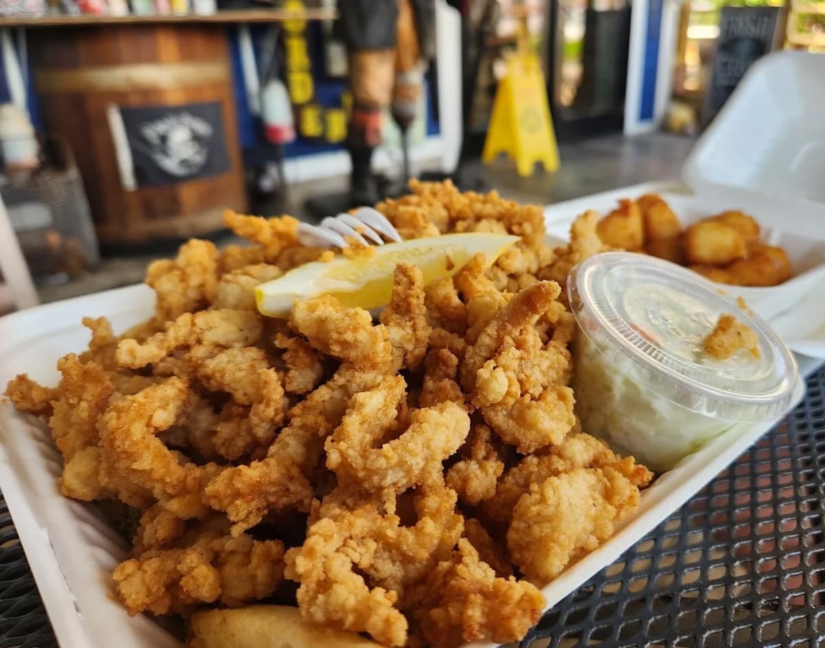 Crispy fried whole-belly clams served with a lemon wedge and dipping sauce