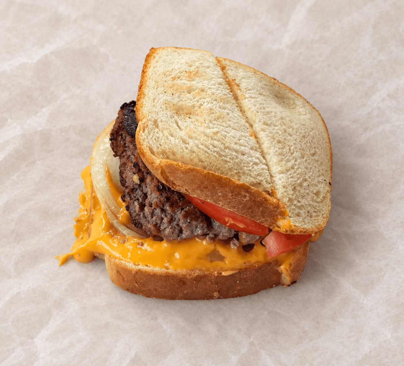 New Haven hamburger with white toast, melted cheese, onion, and tomato