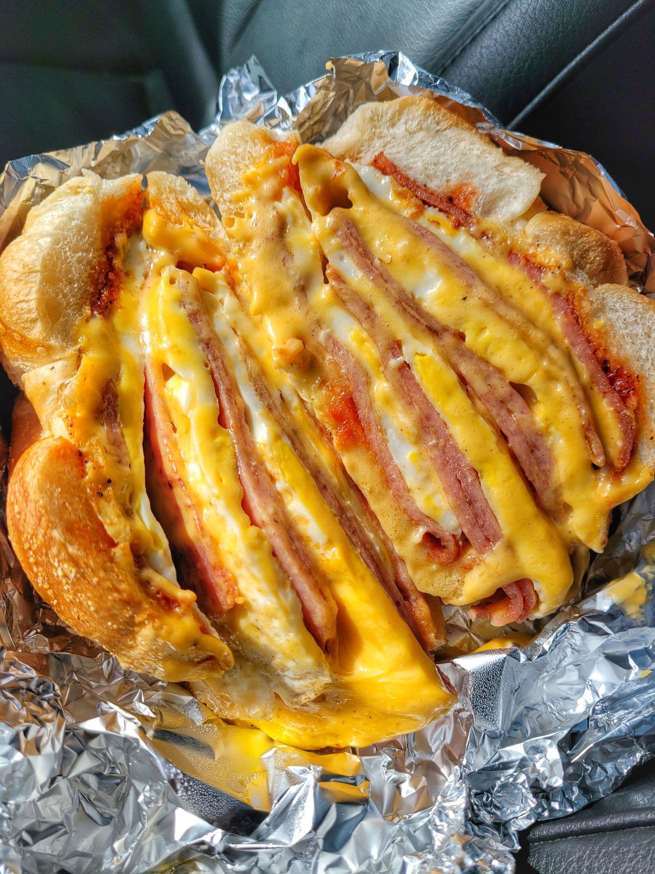 Pork roll, egg, and cheese breakfast sandwich cut open to show layers of meat, egg, and melted cheese