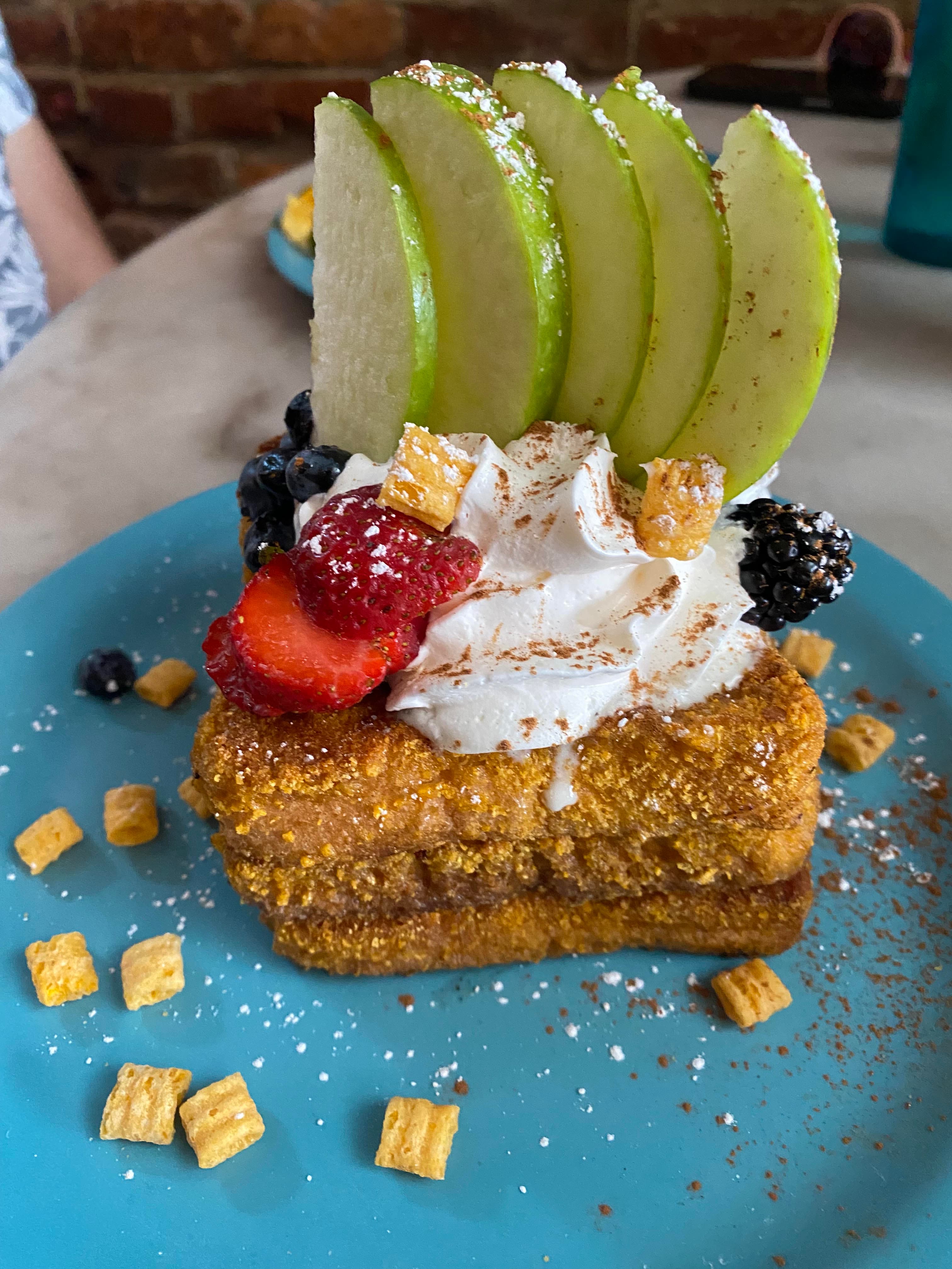 Captain Crunch French toast topped with fruit and whipped cream