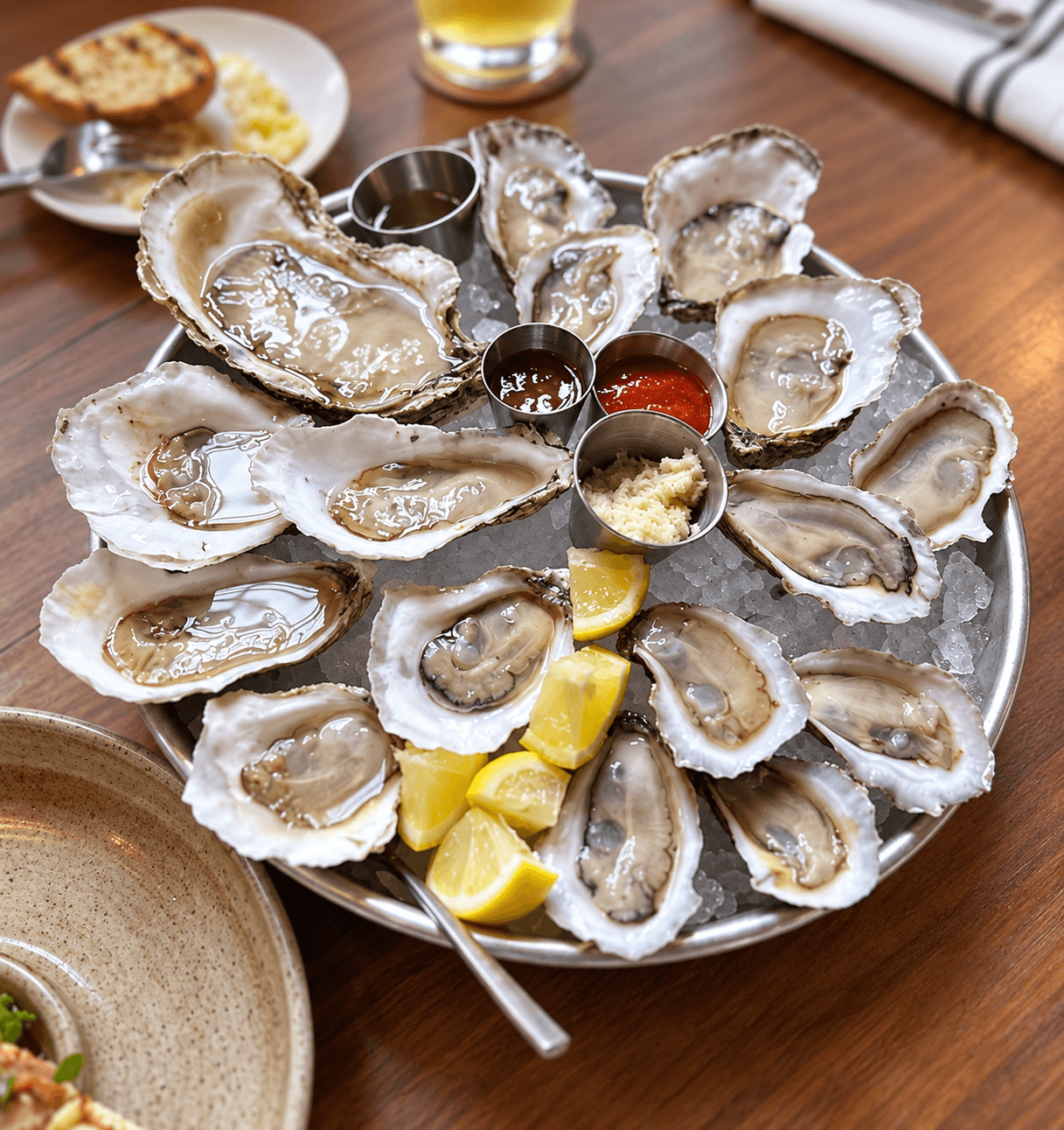 Raw Chesapeake oysters served on ice with lemon wedges and dipping sauces