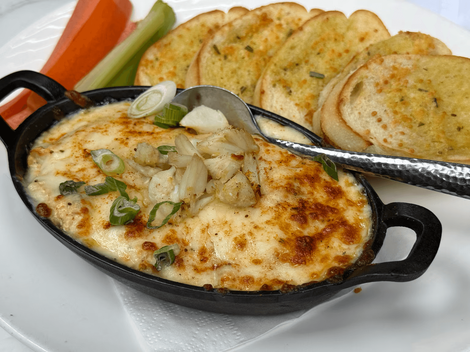 Baltimore crab dip served with toasted bread and vegetables