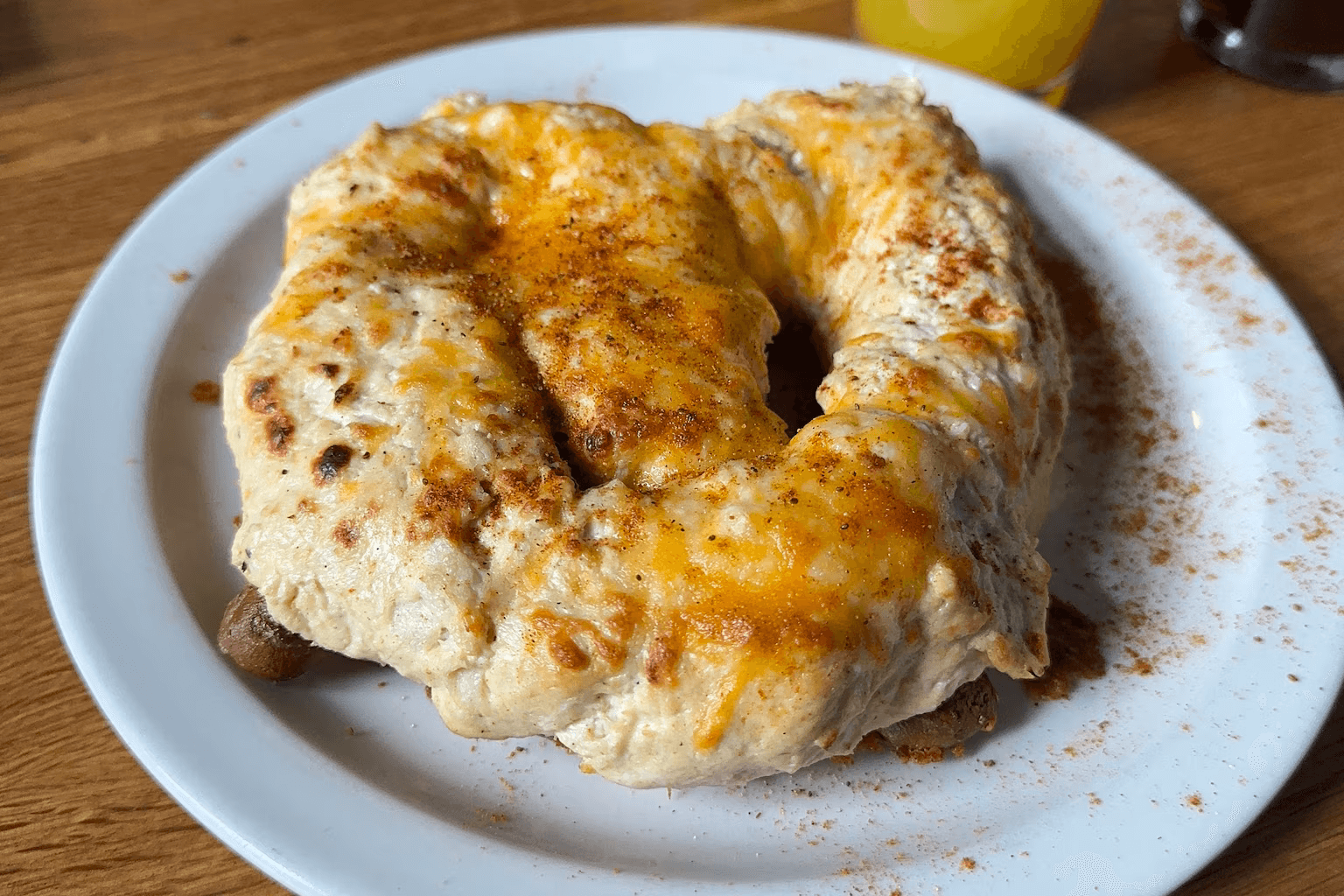 Crab dip pretzel with melted cheese and scallions