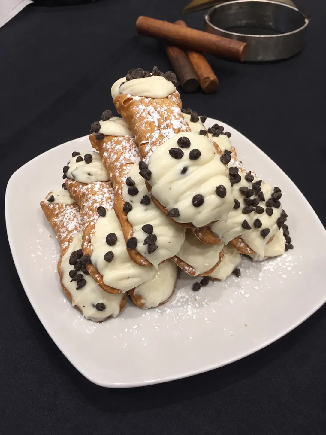 Cannoli filled with cream and topped with chocolate chips