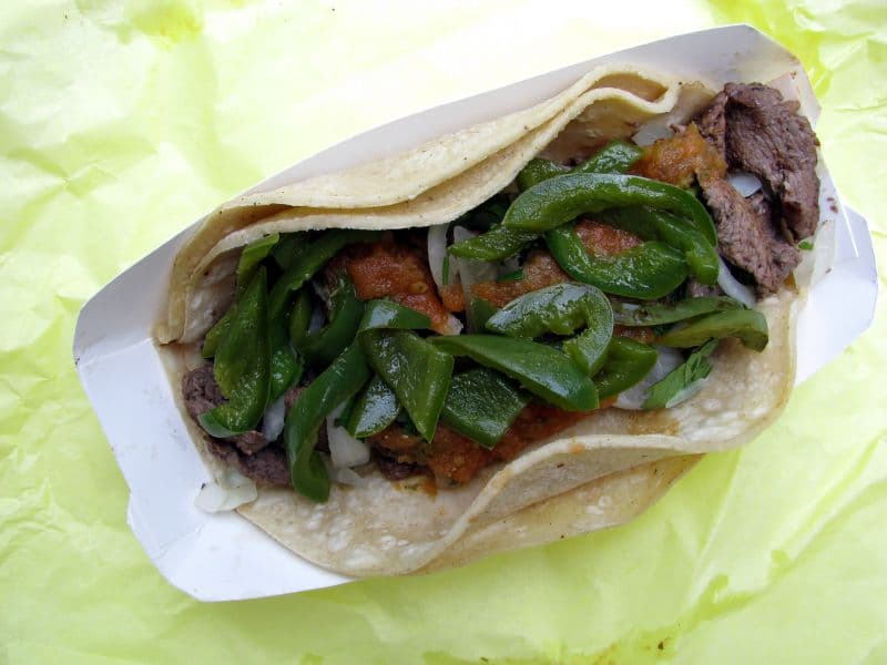 Simple beef taco topped with onion and salsa