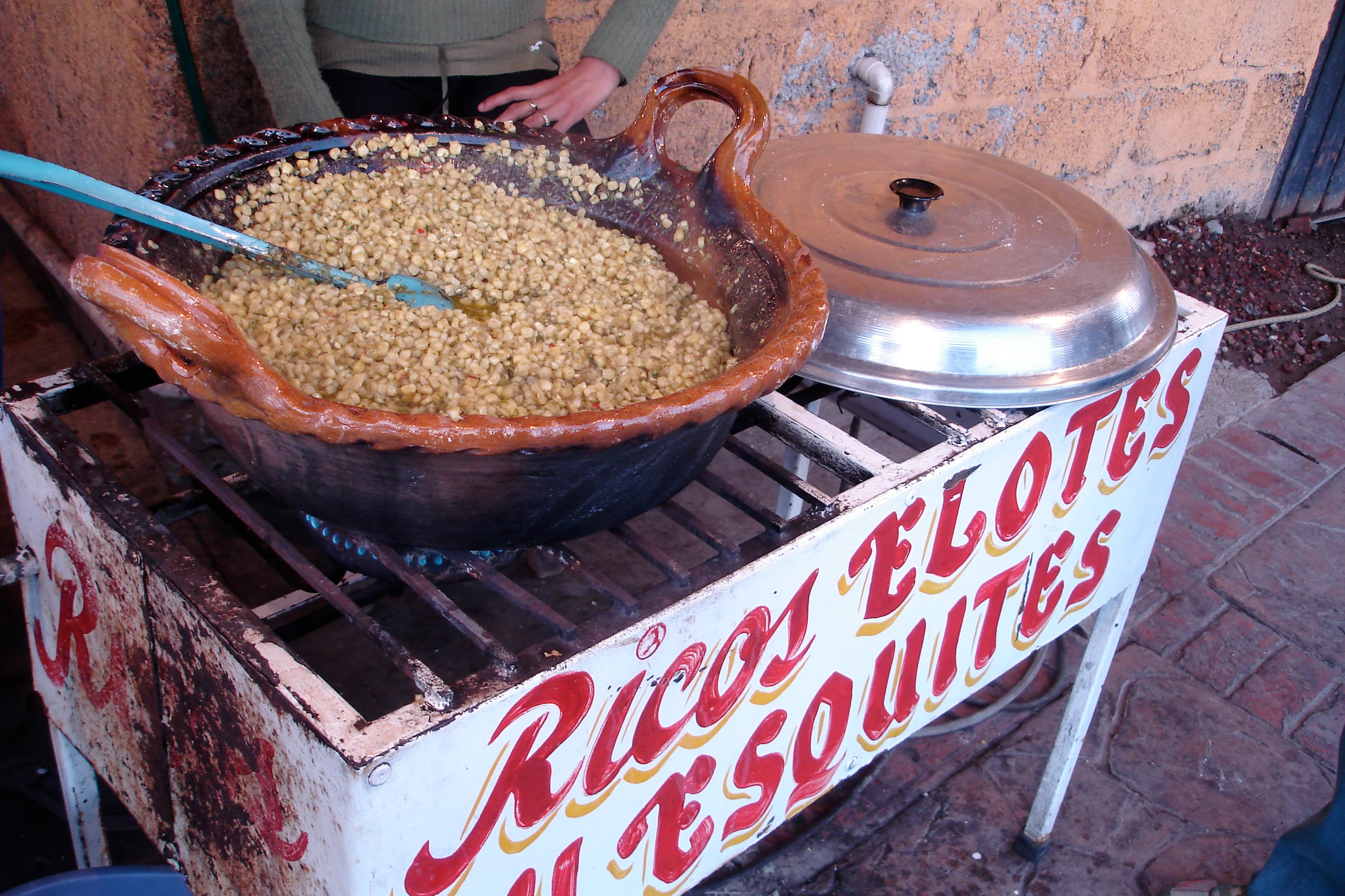 Cup of esquites made with corn, cheese, and chile