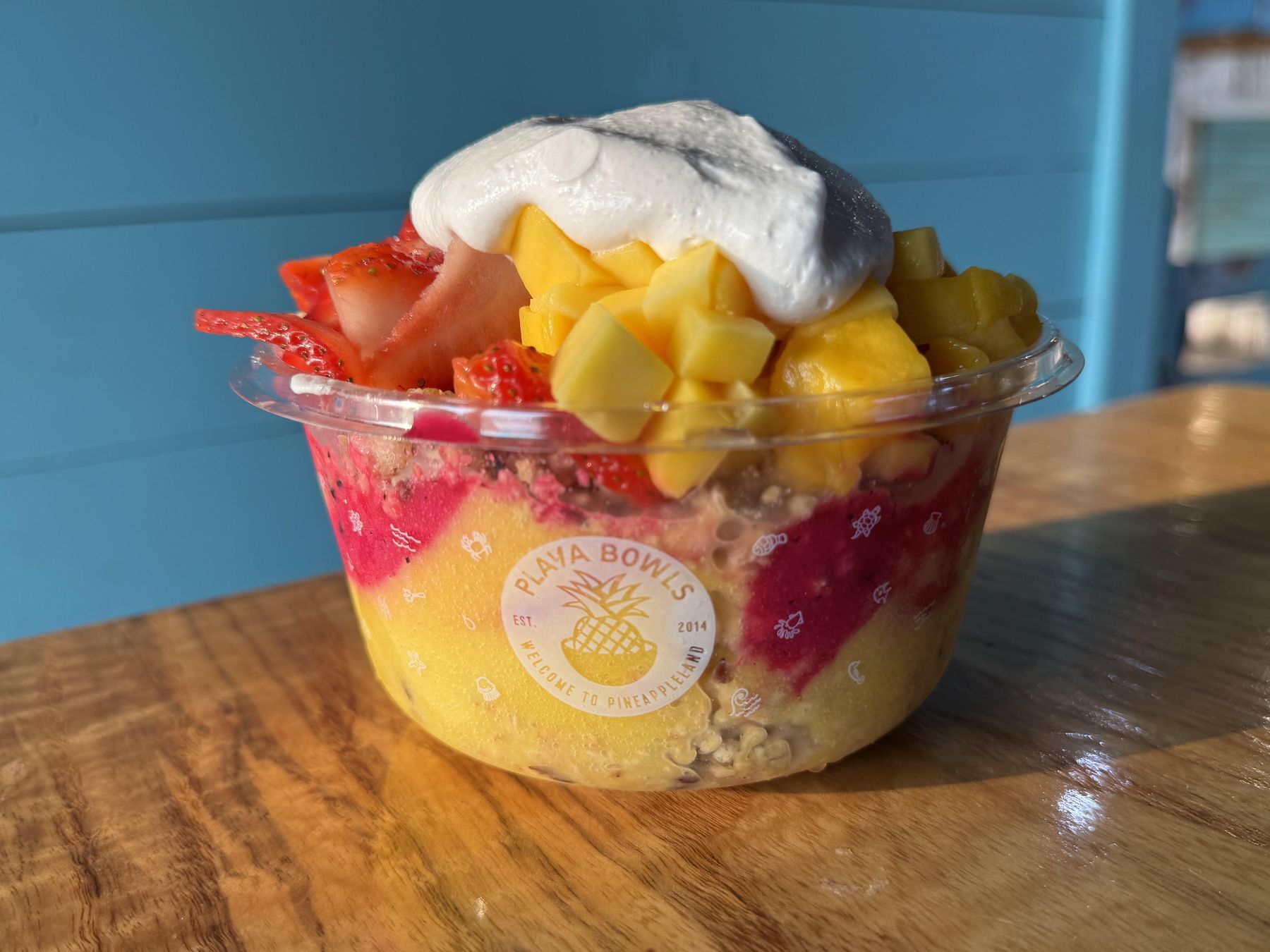 A Jersey Shore açaí and fruit bowl topped with mango, strawberries, and creamy coconut at Playa Bowls