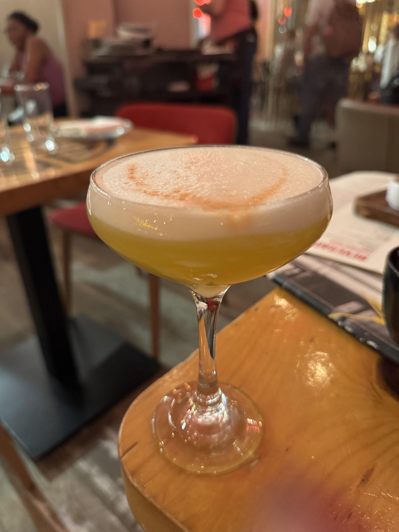 A pisco sour cocktail served in Lima with a frothy top