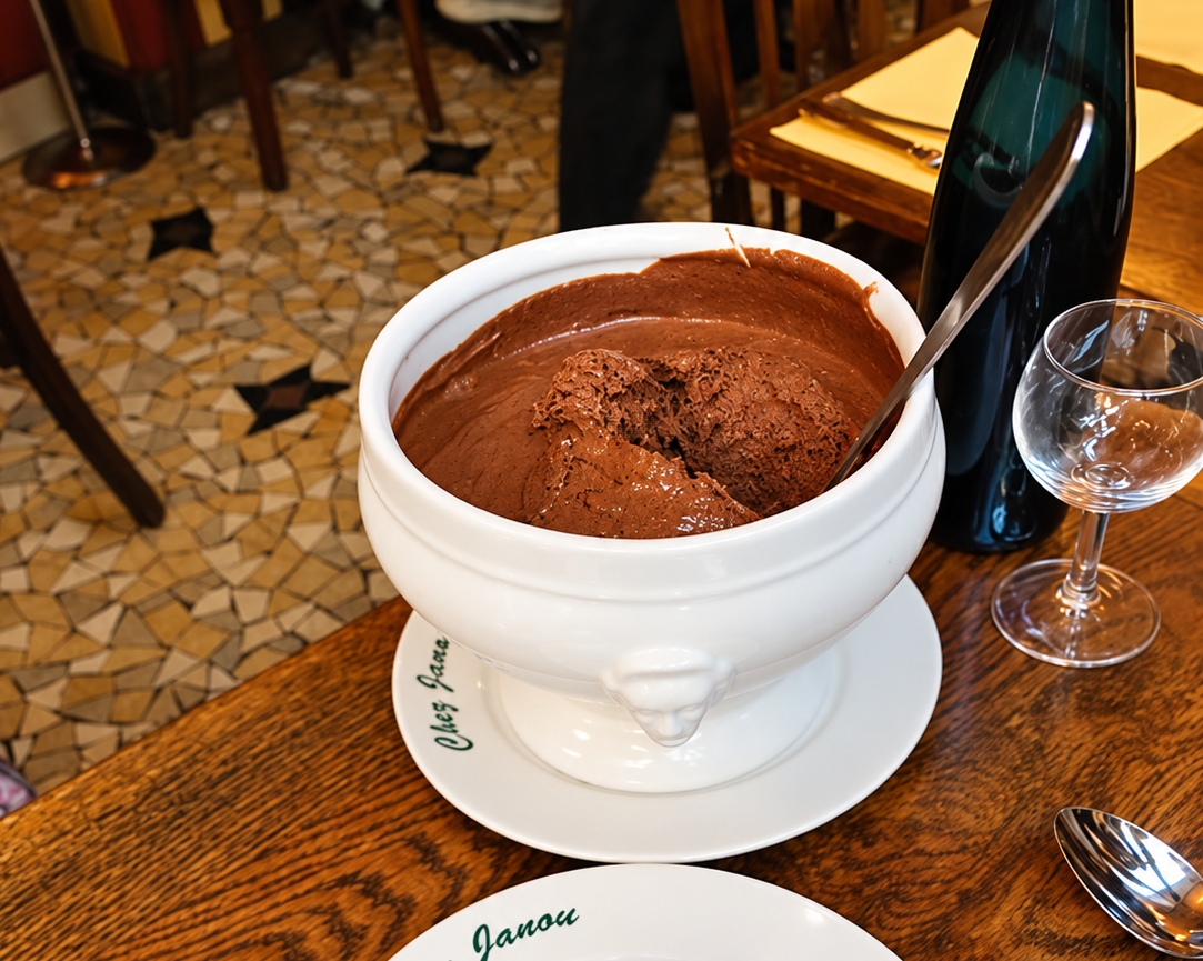 Chocolate mousse served from a large white bowl at a Paris restaurant