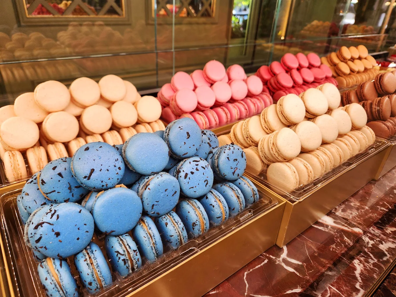 Colorful macarons in a Paris patisserie display