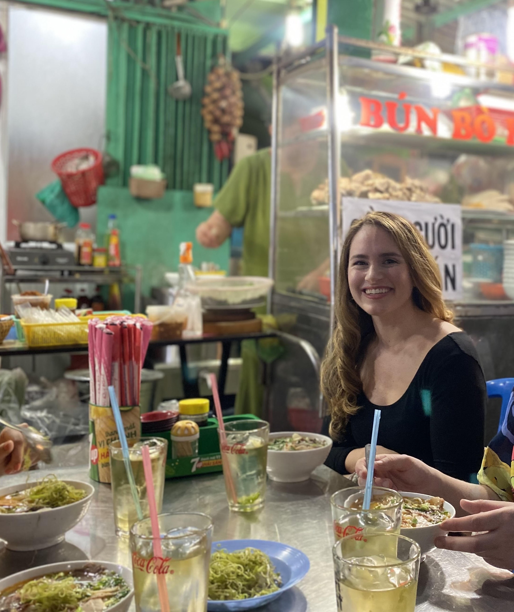 Sarah at a lively street food table